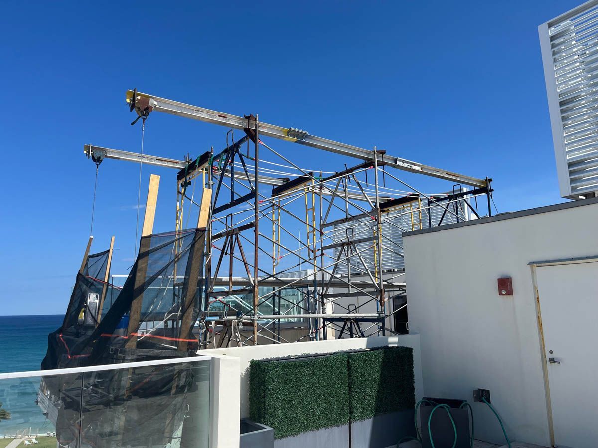 A building is being built on a roof overlooking the ocean.