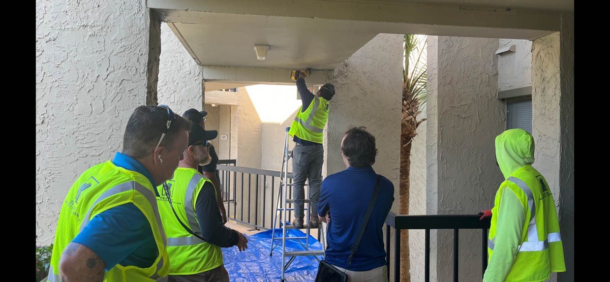A group of construction workers are working on a building.