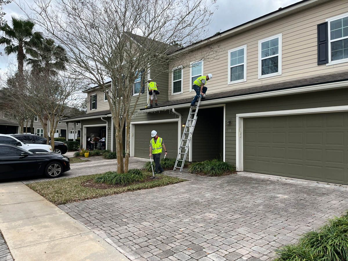 Two men are working on the roof of a house.