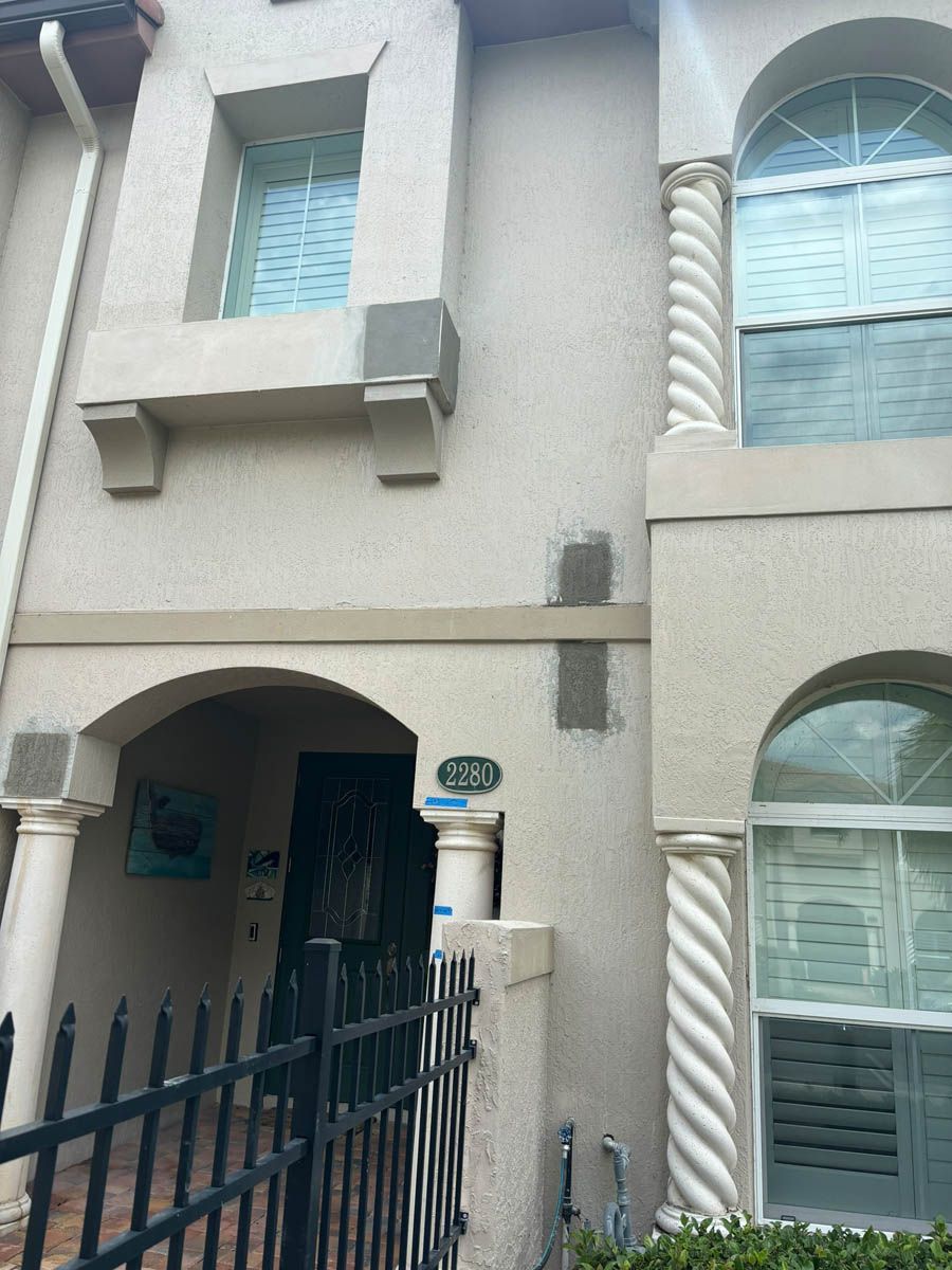 The front of a house with a fence around it