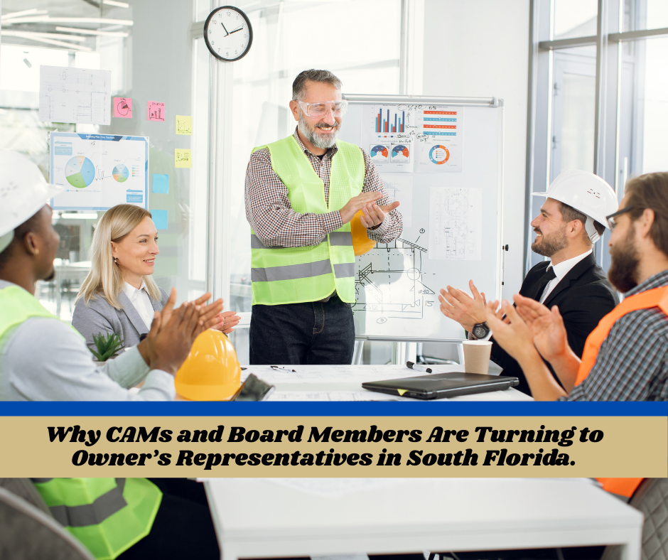 Group applauds a man in a vest at a meeting. Sign reads 