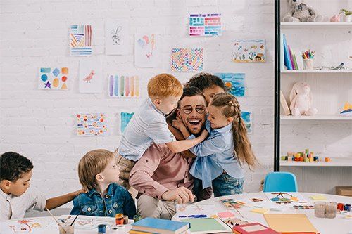 Kids Hugging Their Teacher