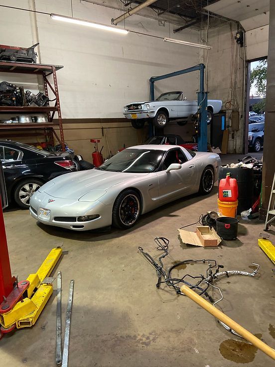 Silver Sports Car Parked Inside an Auto Repair Shop | Alpha Autoworks