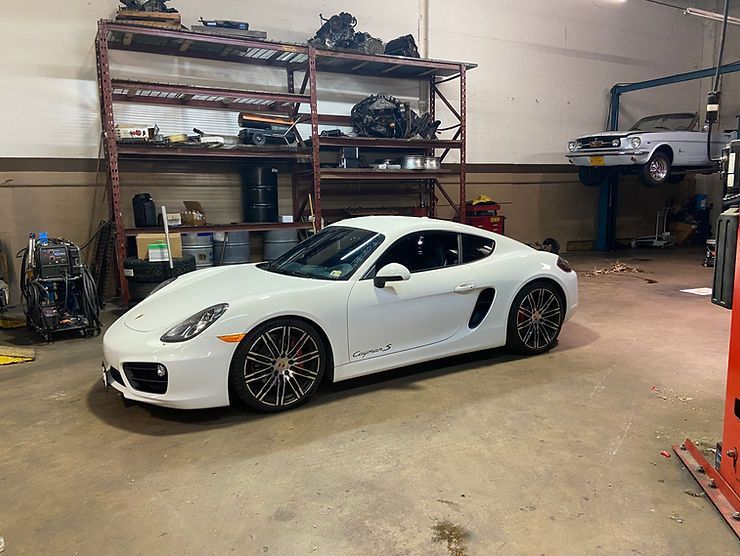 Clean White Sports Car Parked Inside an Auto Repair Shop | Alpha Autoworks