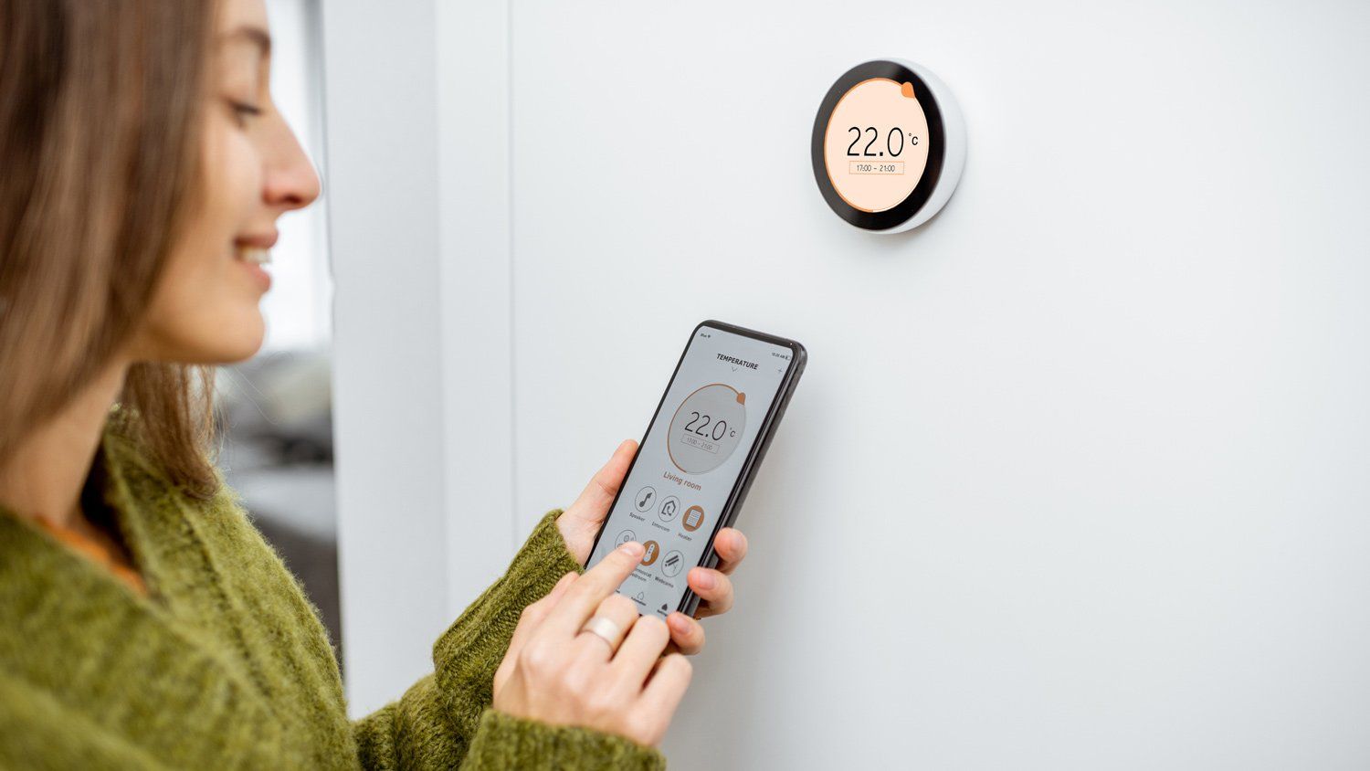 Lady Controlling Thermostat With Phone — Napa, CA — CSA Roofing, Heating & Air