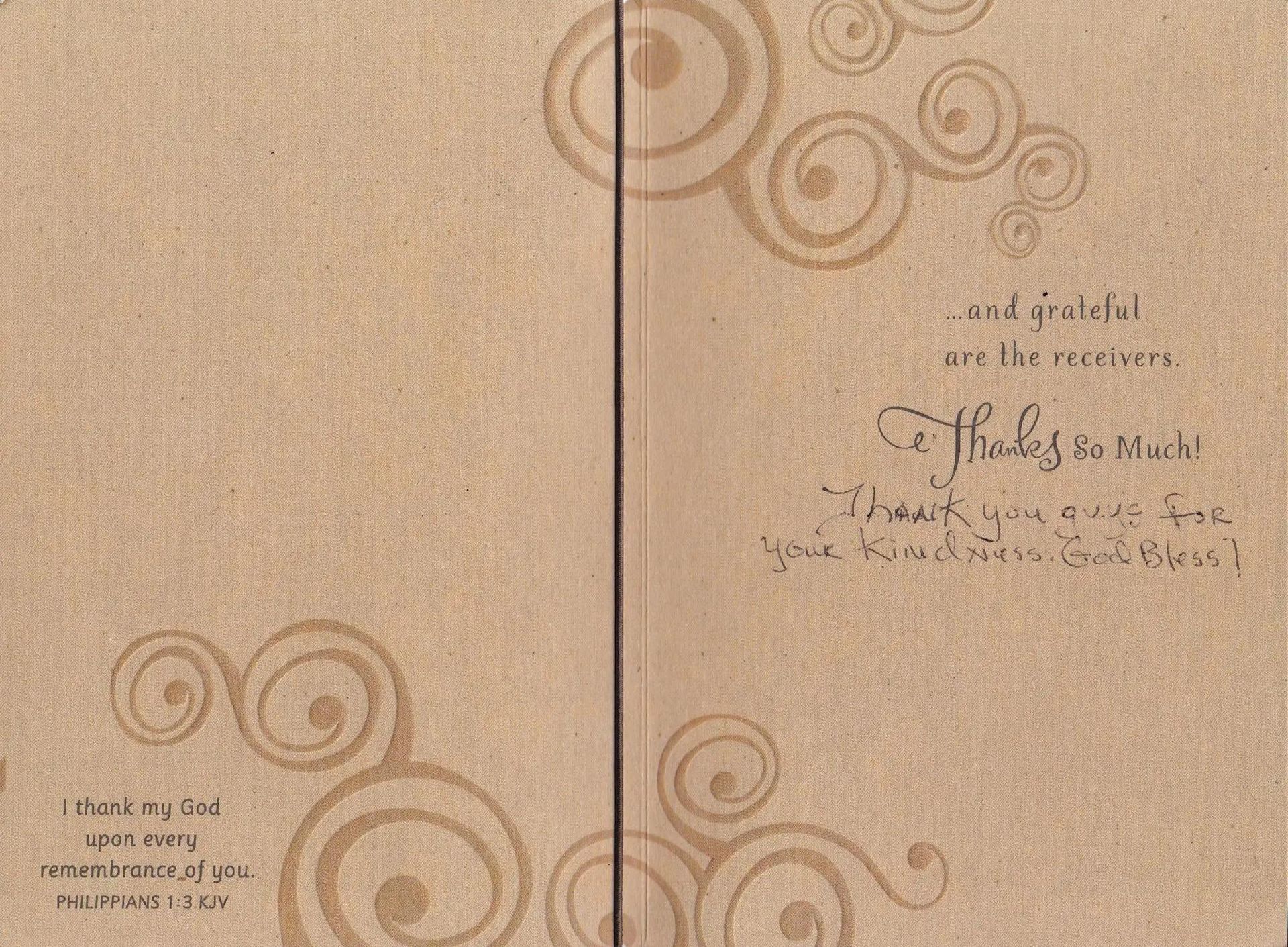 Inside of a beige greeting card with swirling designs. Handwriting says 