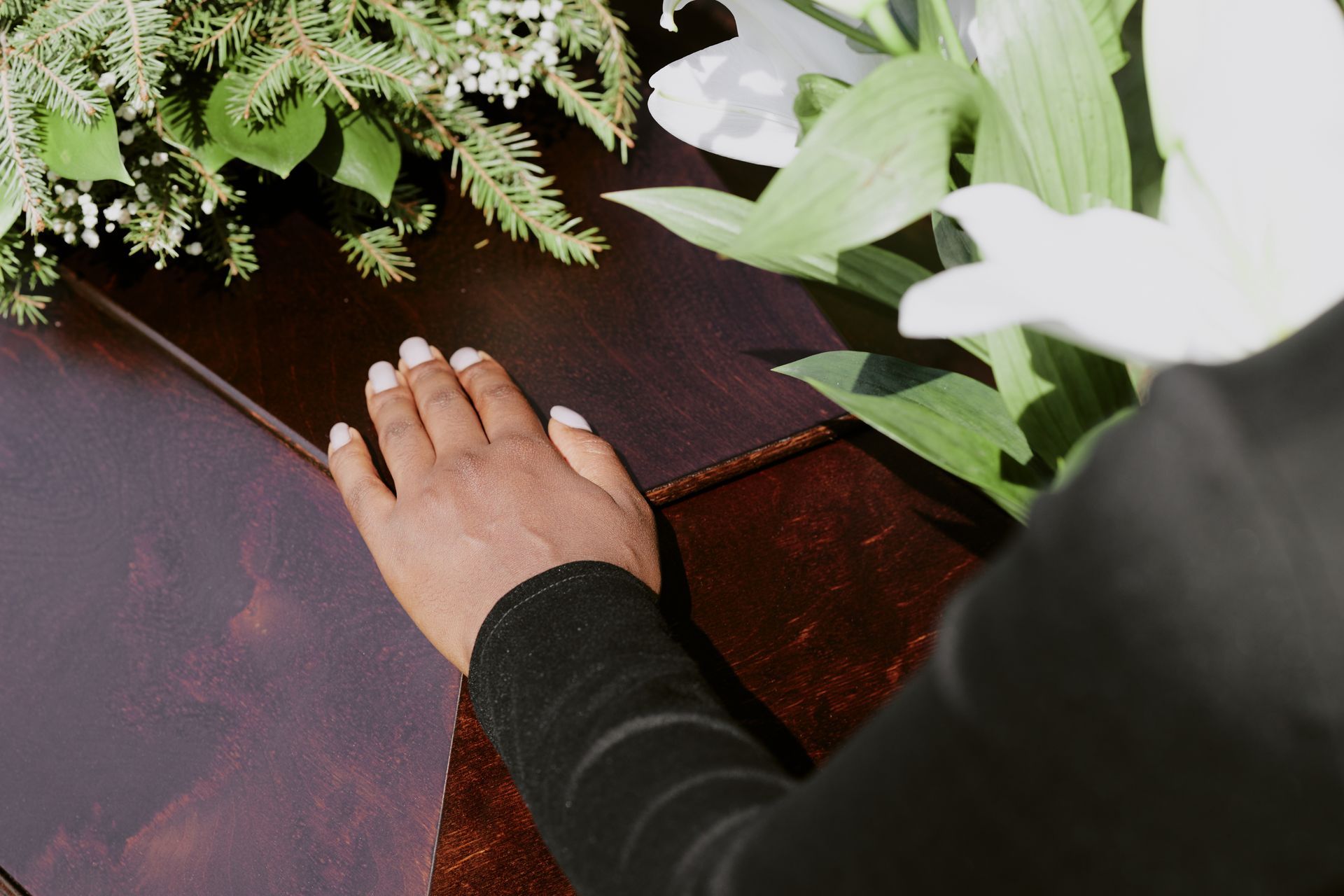 Hands folding an American flag. Stars and stripes visible.