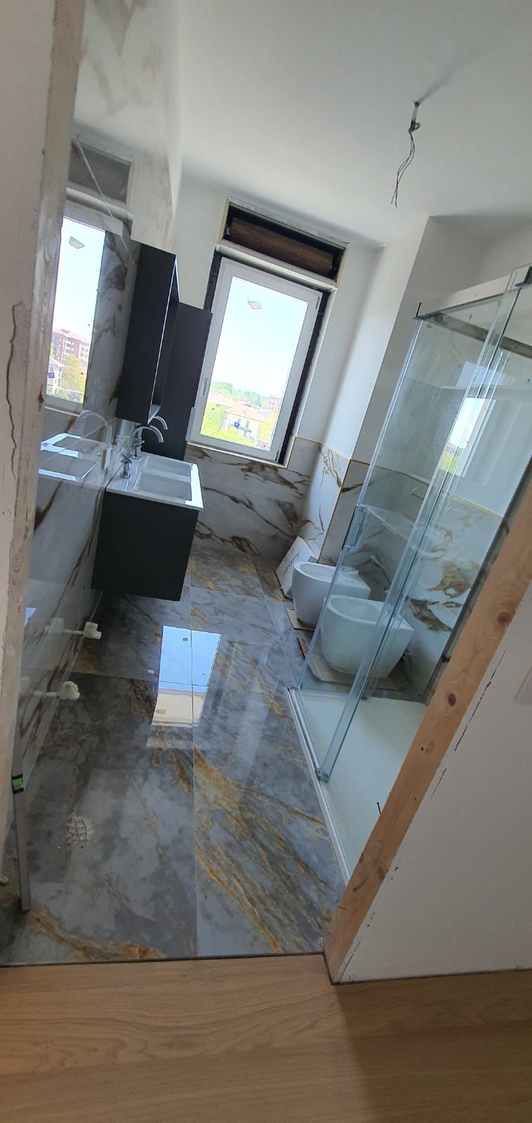 Un bagno con lavandino, water e doccia.