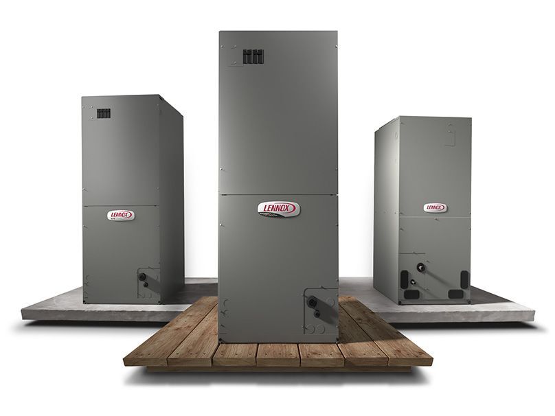 Three air conditioners are sitting on top of a wooden table.