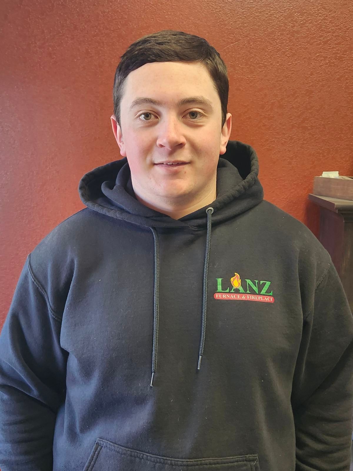 A man wearing a black hoodie with the word lanz on it