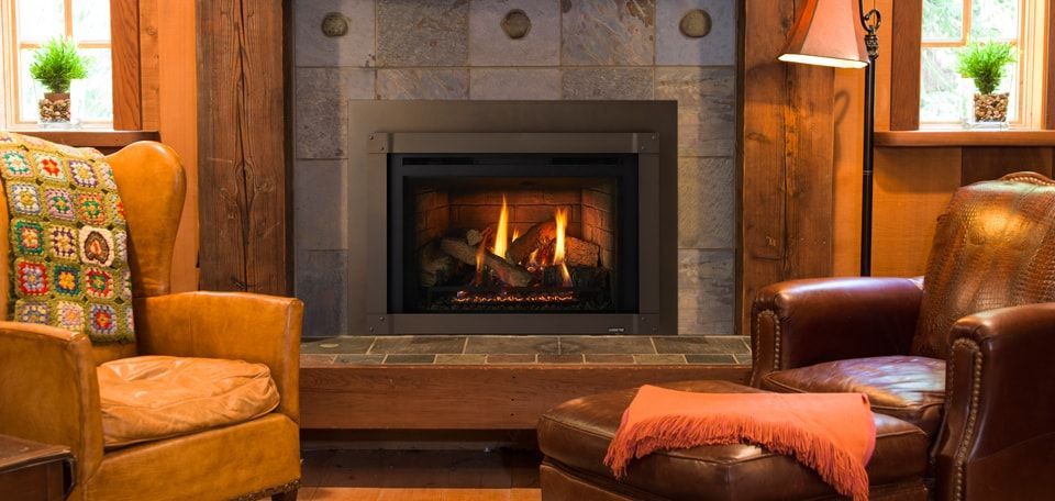 A fireplace is sitting in a living room next to a window.
