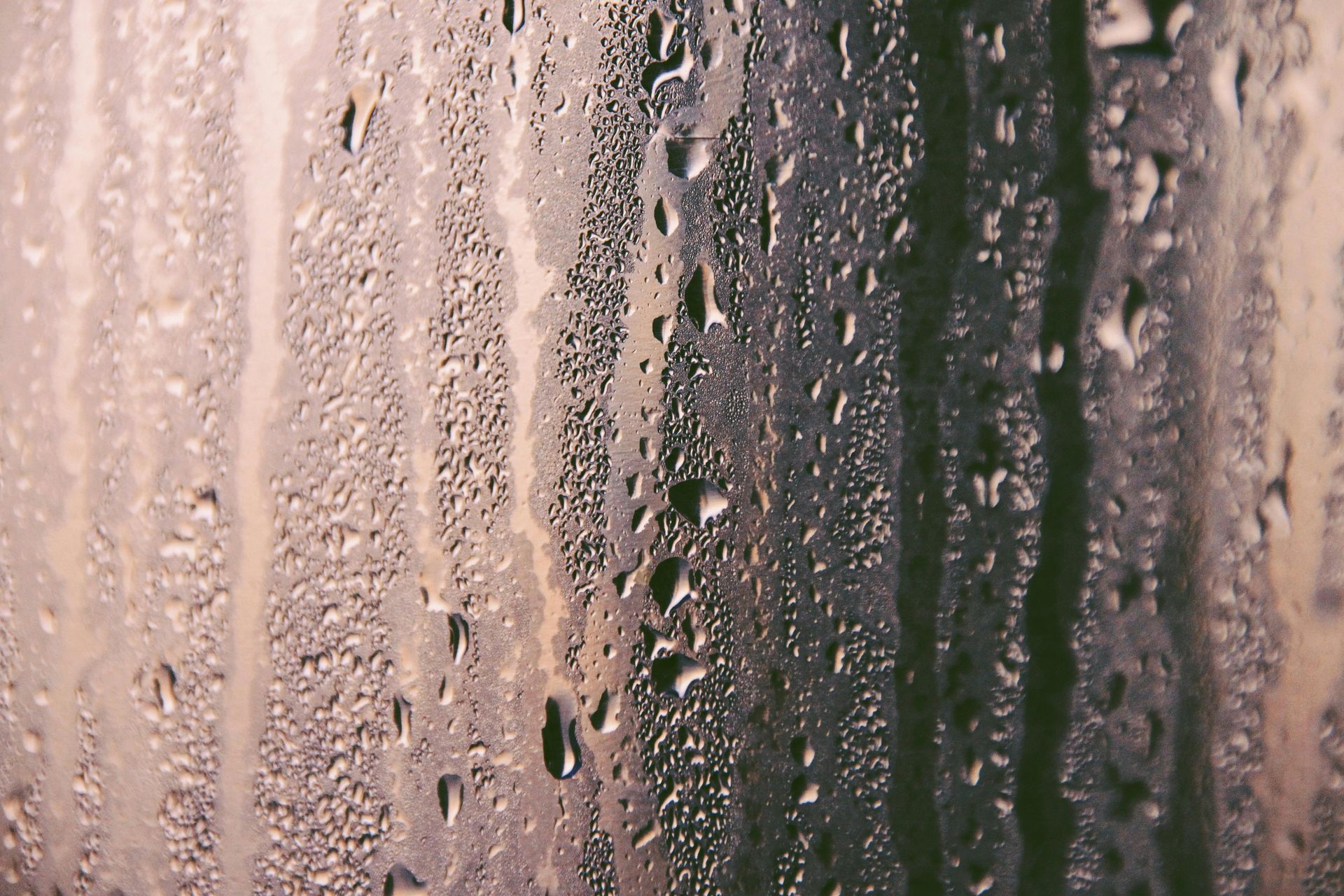 A close up of water drops on a window.