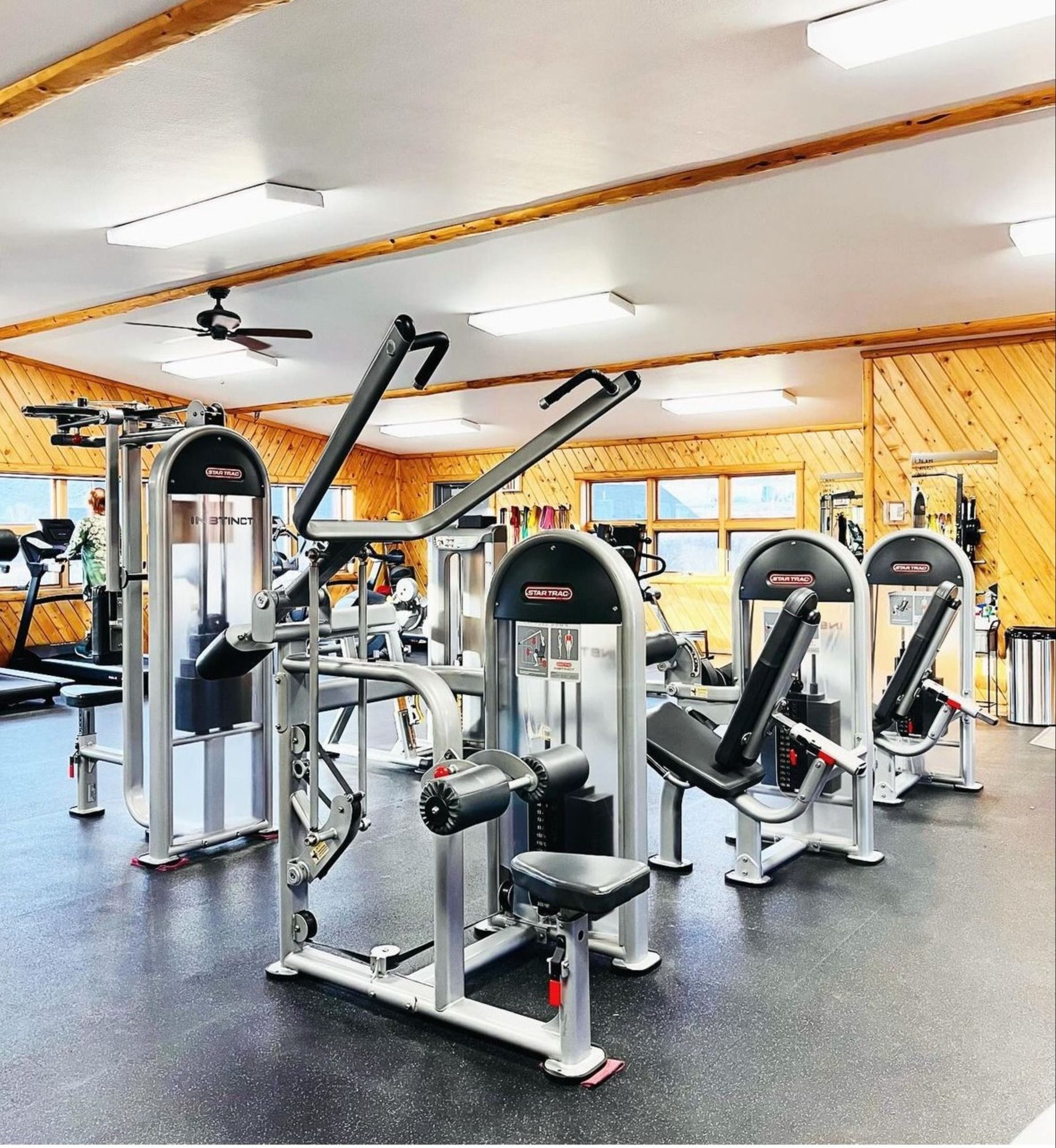 A large gym filled with lots of exercise equipment