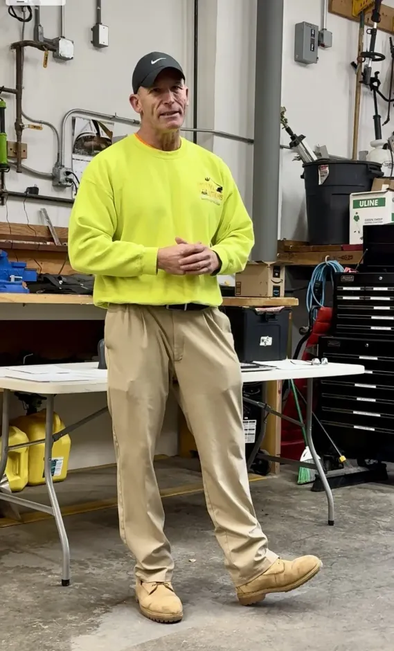 Paul Soracco of Motive Solutions LLC stands in a certification workshop, hands clasped, looking towards the camera.