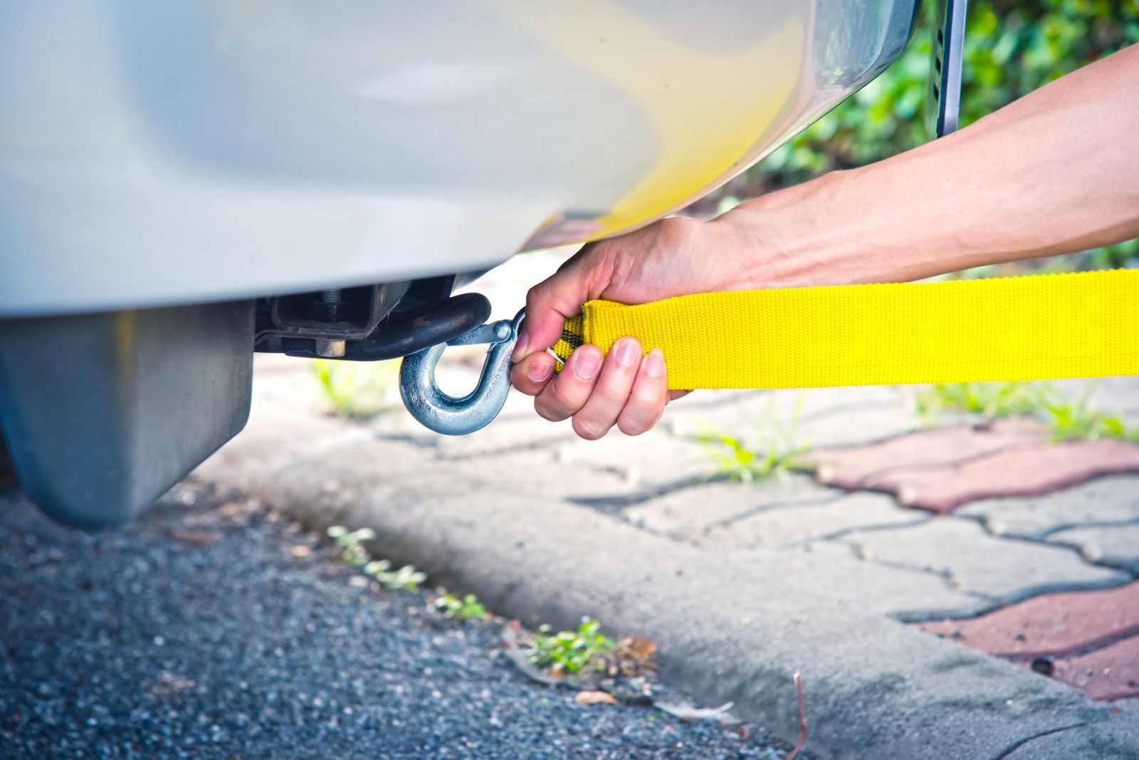 A man and a woman are standing next to a tow truck.