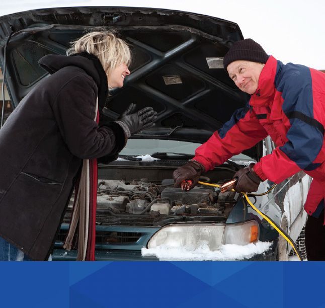 Two person smiling, fixing a car issue | McWilliams & Walden Inc.