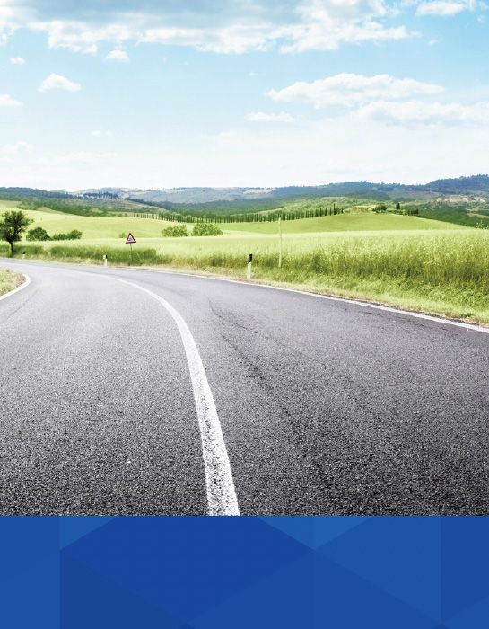 A road near green fields | McWilliams & Walden Inc.