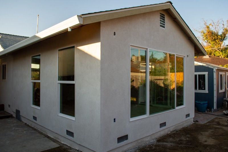 A white house with a lot of windows and a roof