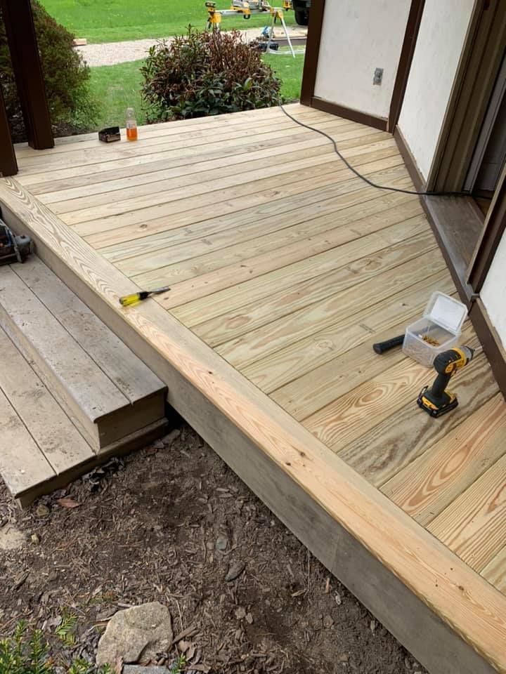 A wooden deck is being built on the side of a house.