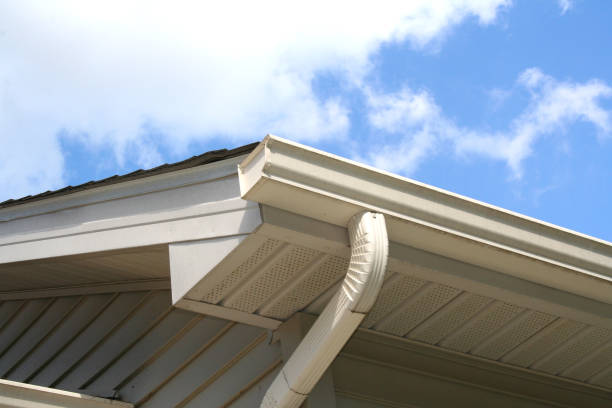 A gutter on the side of a house with a blue sky in the background