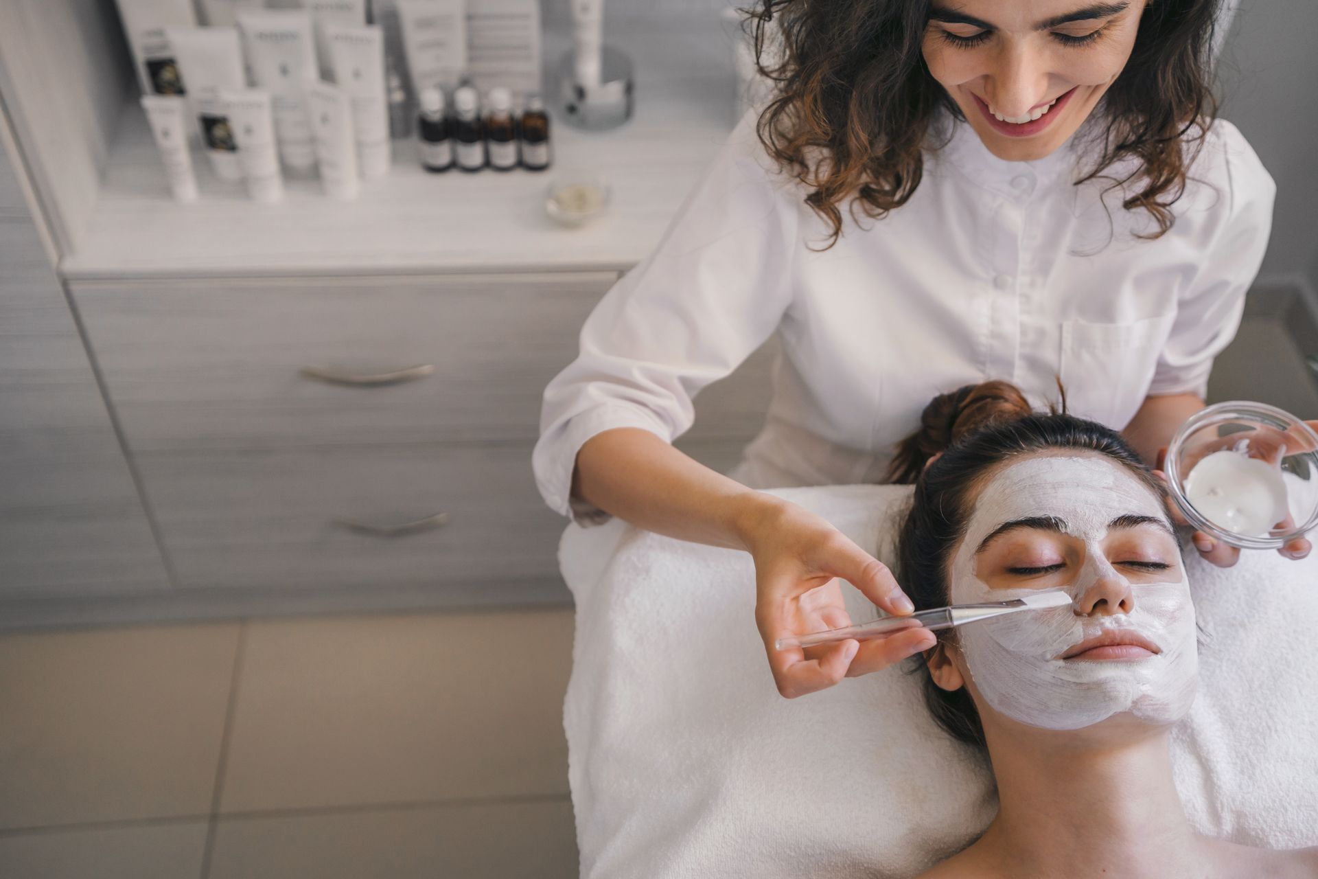 A woman is getting a facial treatment at a spa.