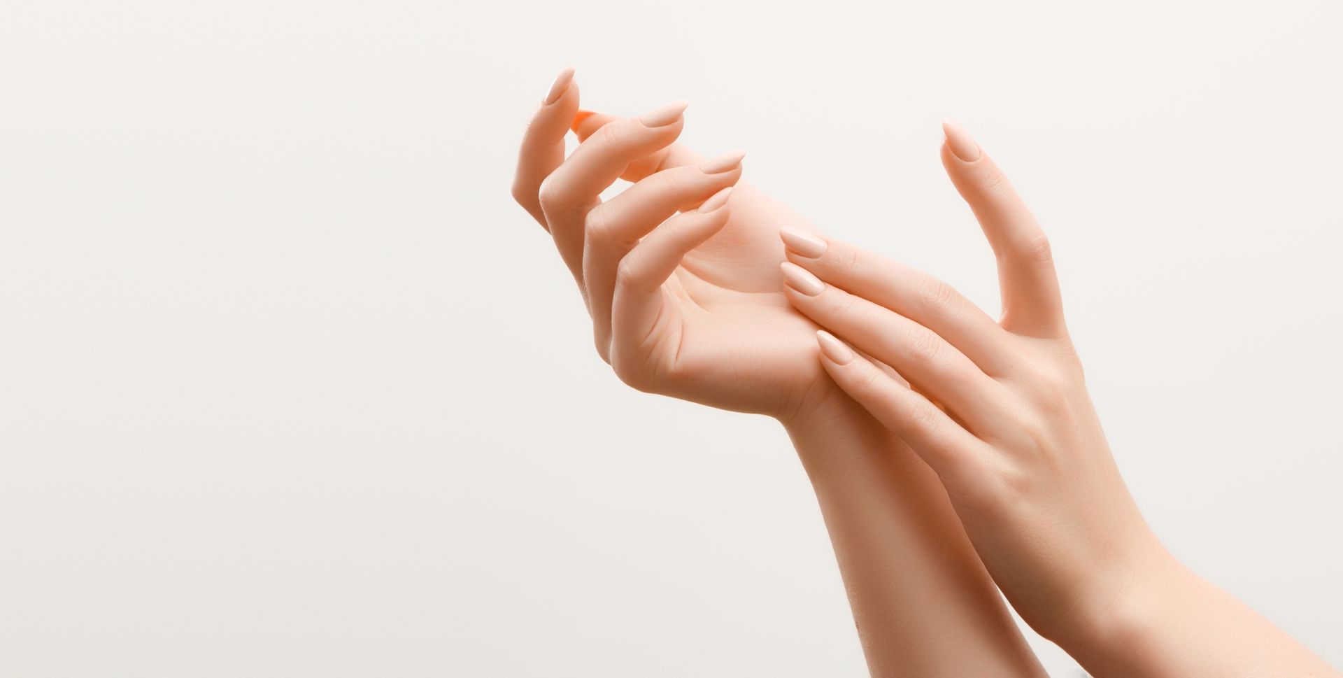 A close up of a woman 's hands on a white background.