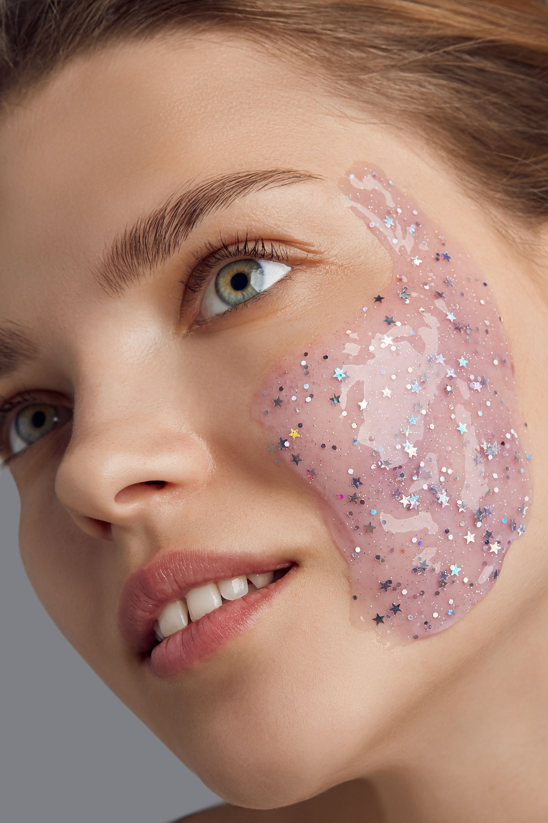 A close up of a woman 's face with a pink mask on it.