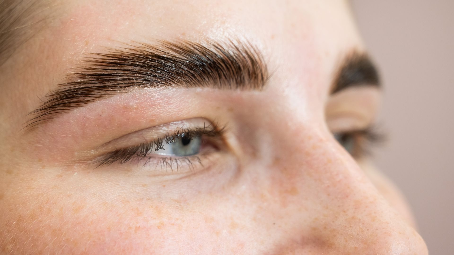 A close up of a woman 's eye and eyebrows.