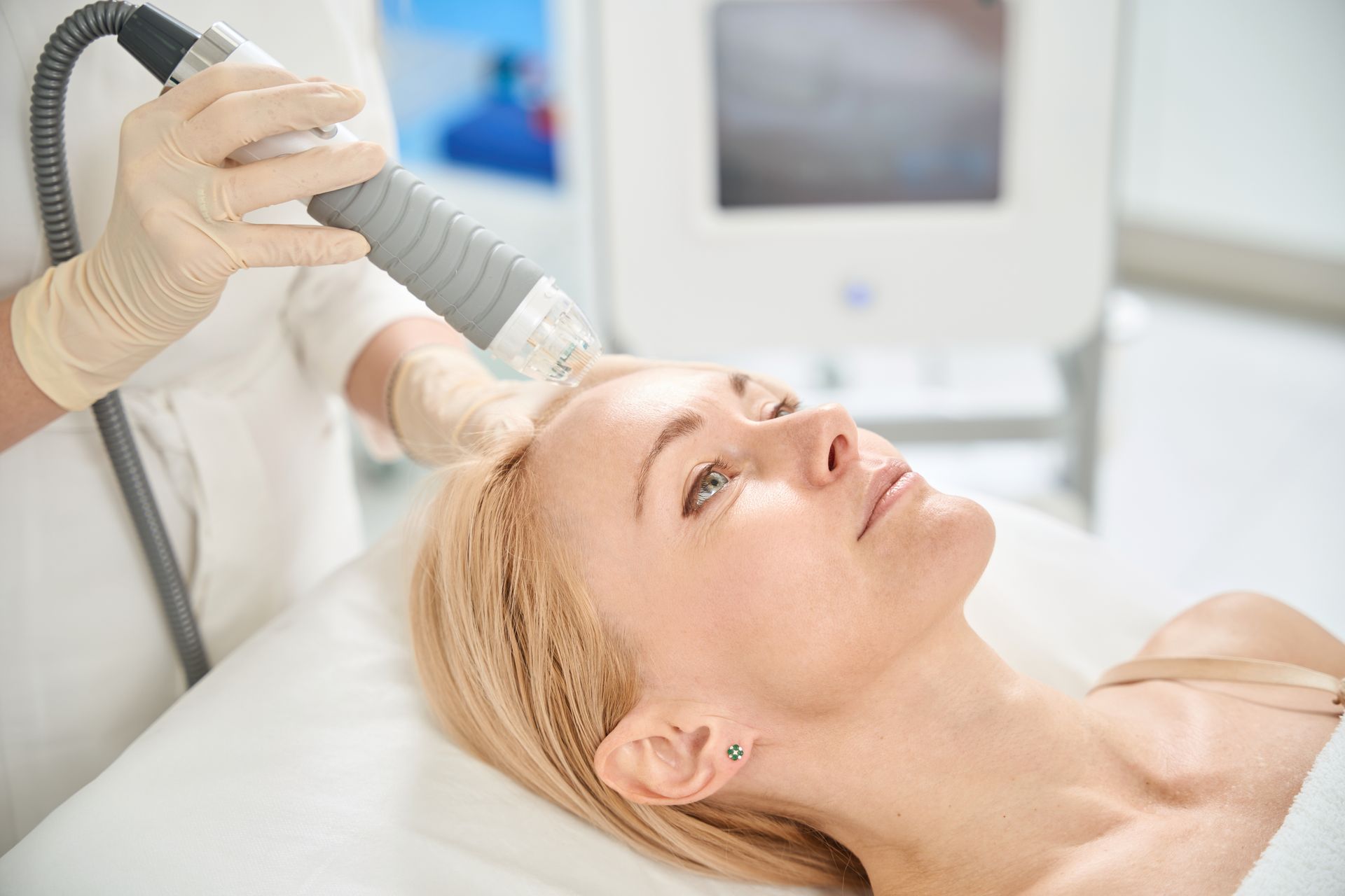 A woman is getting a facial treatment at a beauty salon.