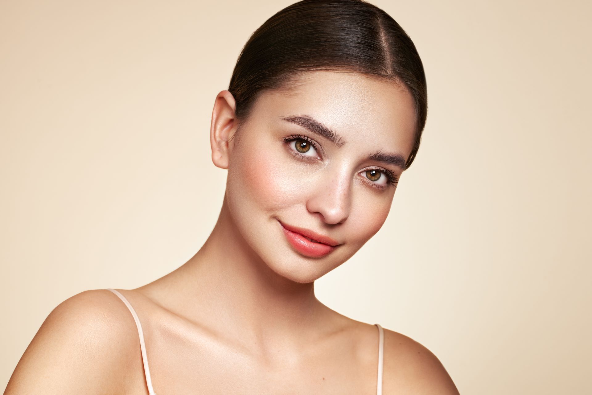 A close up of a woman 's face with a smile on her face.