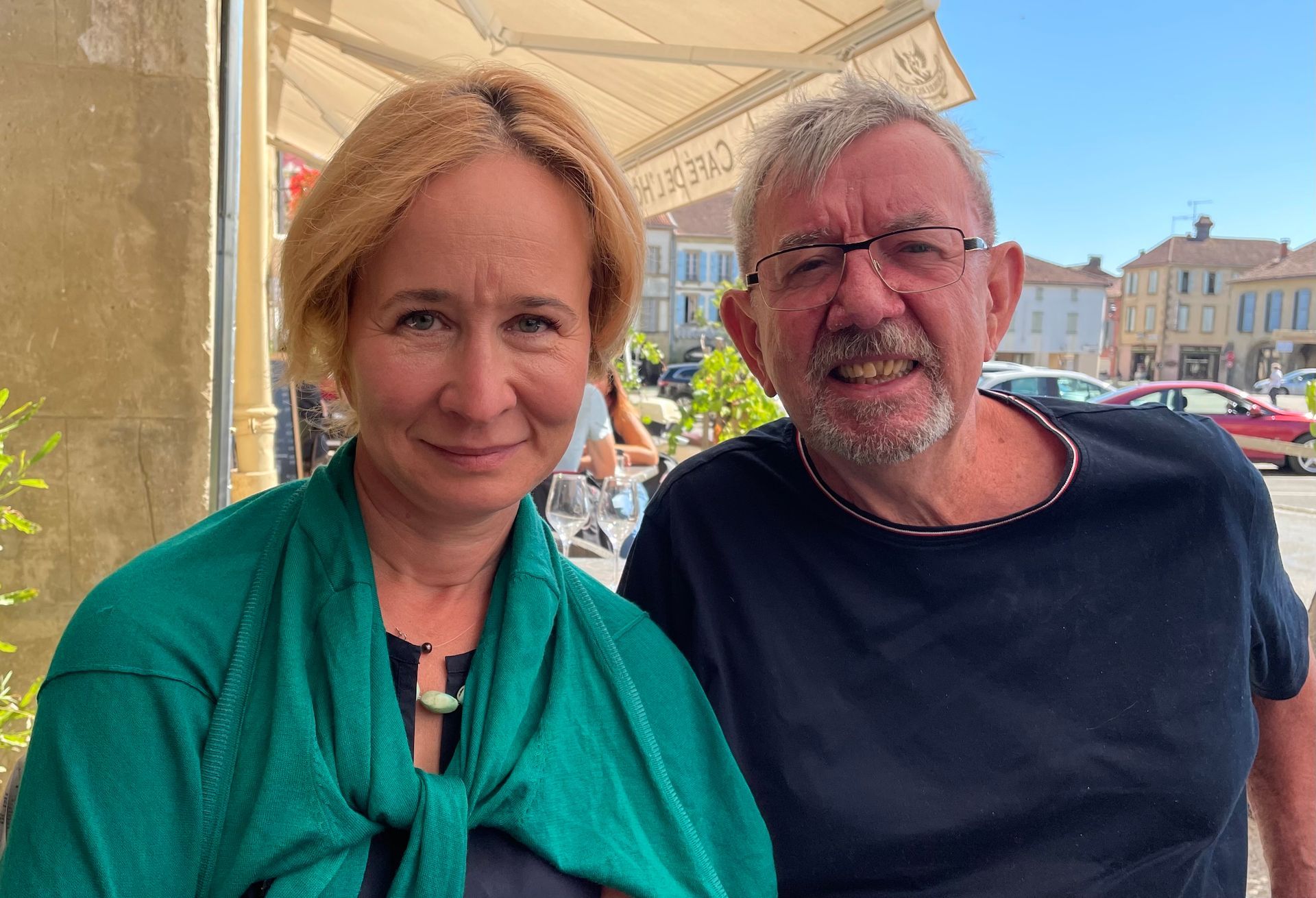 A couple sitting at a cafe 