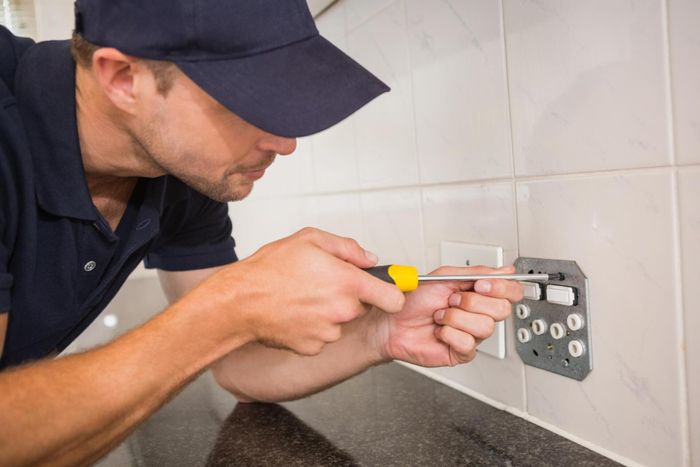 worker using a screwdriver
