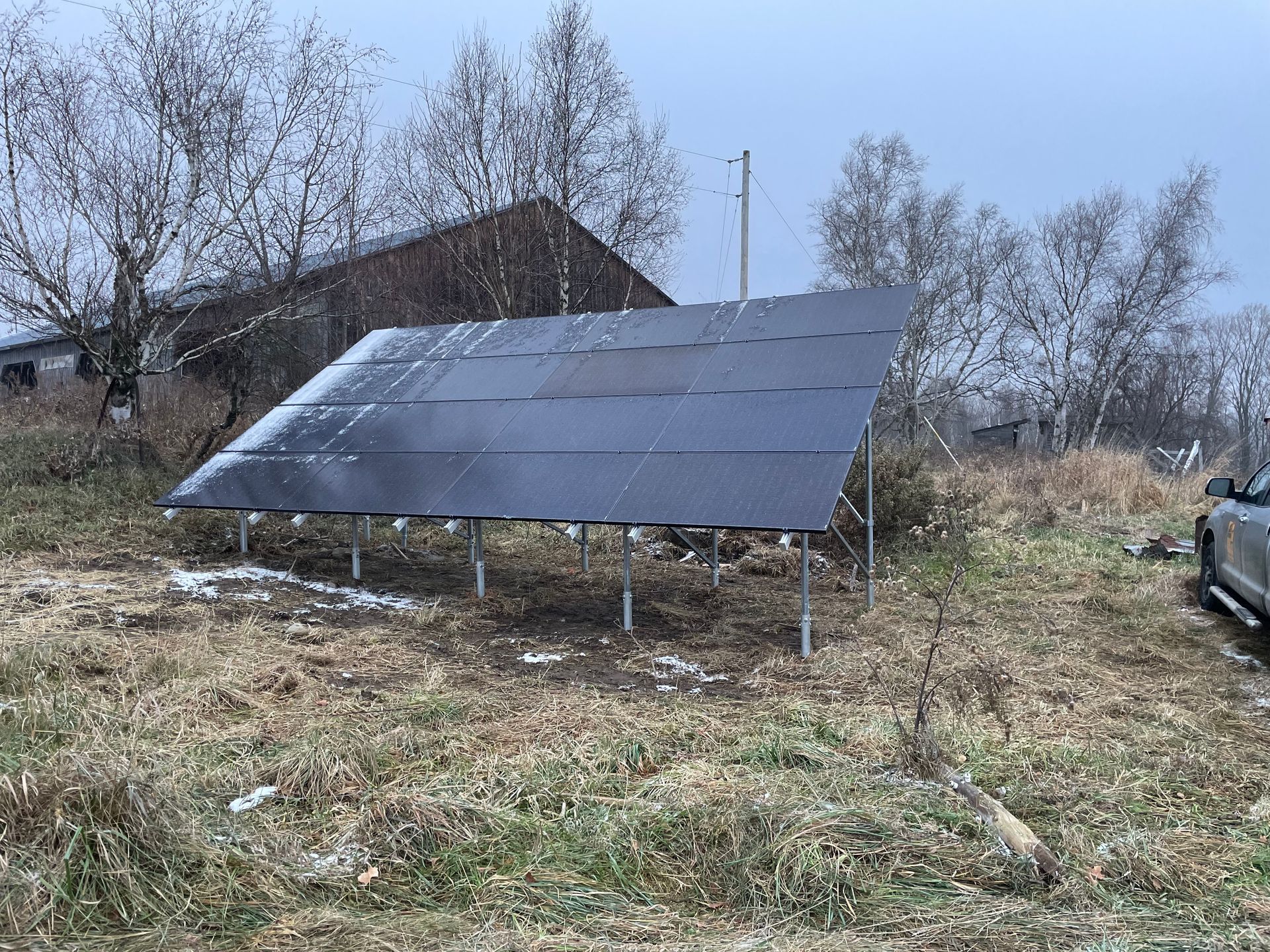 A group of solar panels on posts at a residential setting