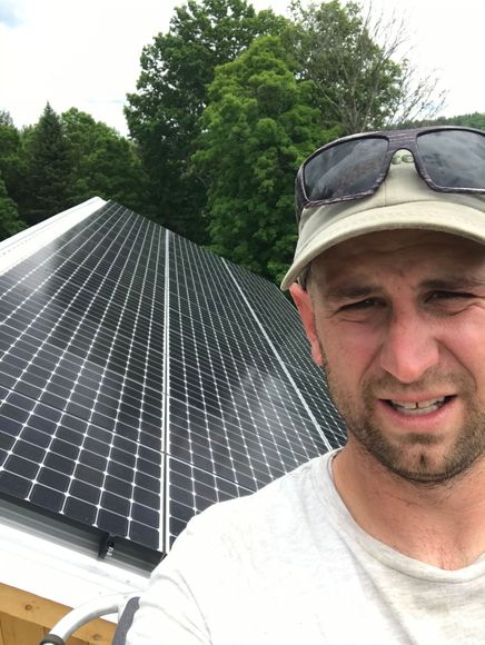 Owner Zeb taking a photo of himself with newly installed solar panels