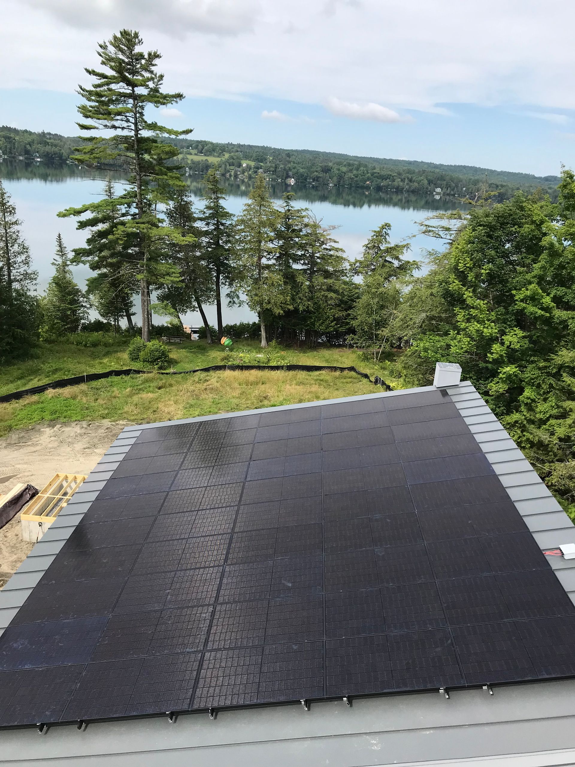 Finished solar panel installed on a roof overlooking a lake