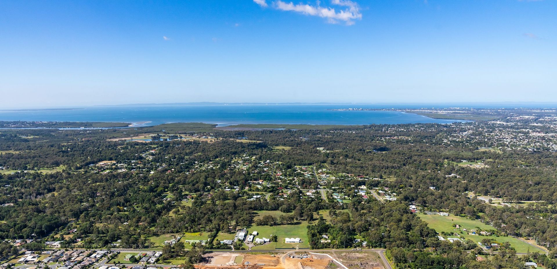 An Aerial View Of A Large Body Of Water With A City In The Background — Brisbane Antenna Specialists in Burpengary East, QLD