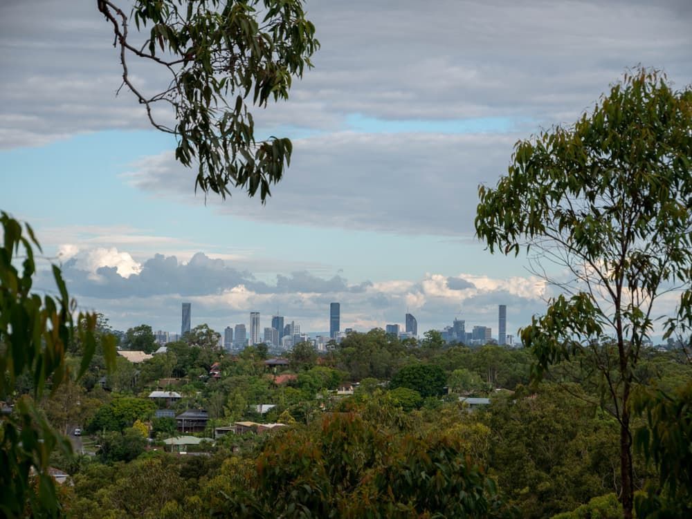 A view of a city from a hill with trees in the foreground — Brisbane Antenna Specialists in Chermside, QLD