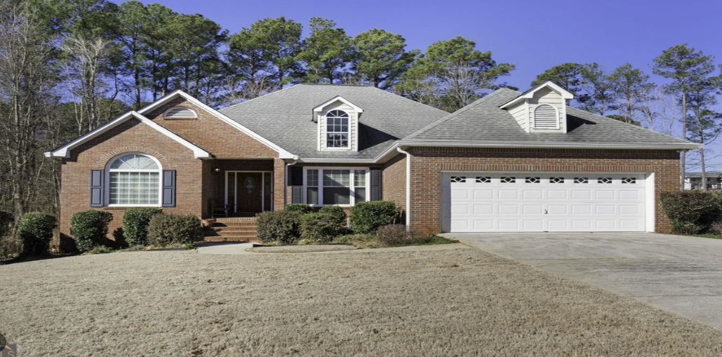 A large house with a car parked in front of it