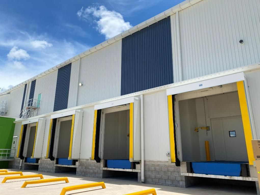 A Side View of a Warehouse Exterior Featuring Four Loading Docks — Arctic Installations in Winnellie, NT