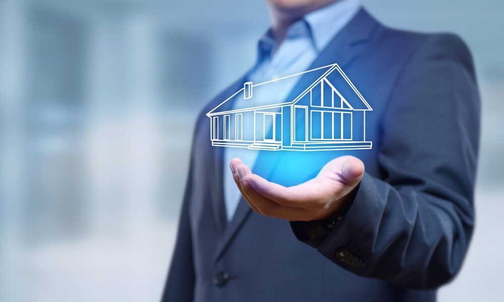 A Man in A Suit Is Holding a House in His Hand — Arctic Installations in Mildura, VIC