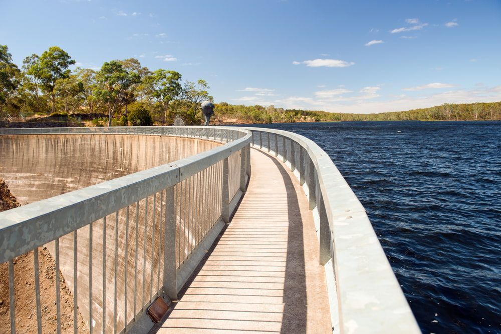 A Wooden Walkway Leading to A Large Body of Water — Arctic Installations in Adelaide, NT