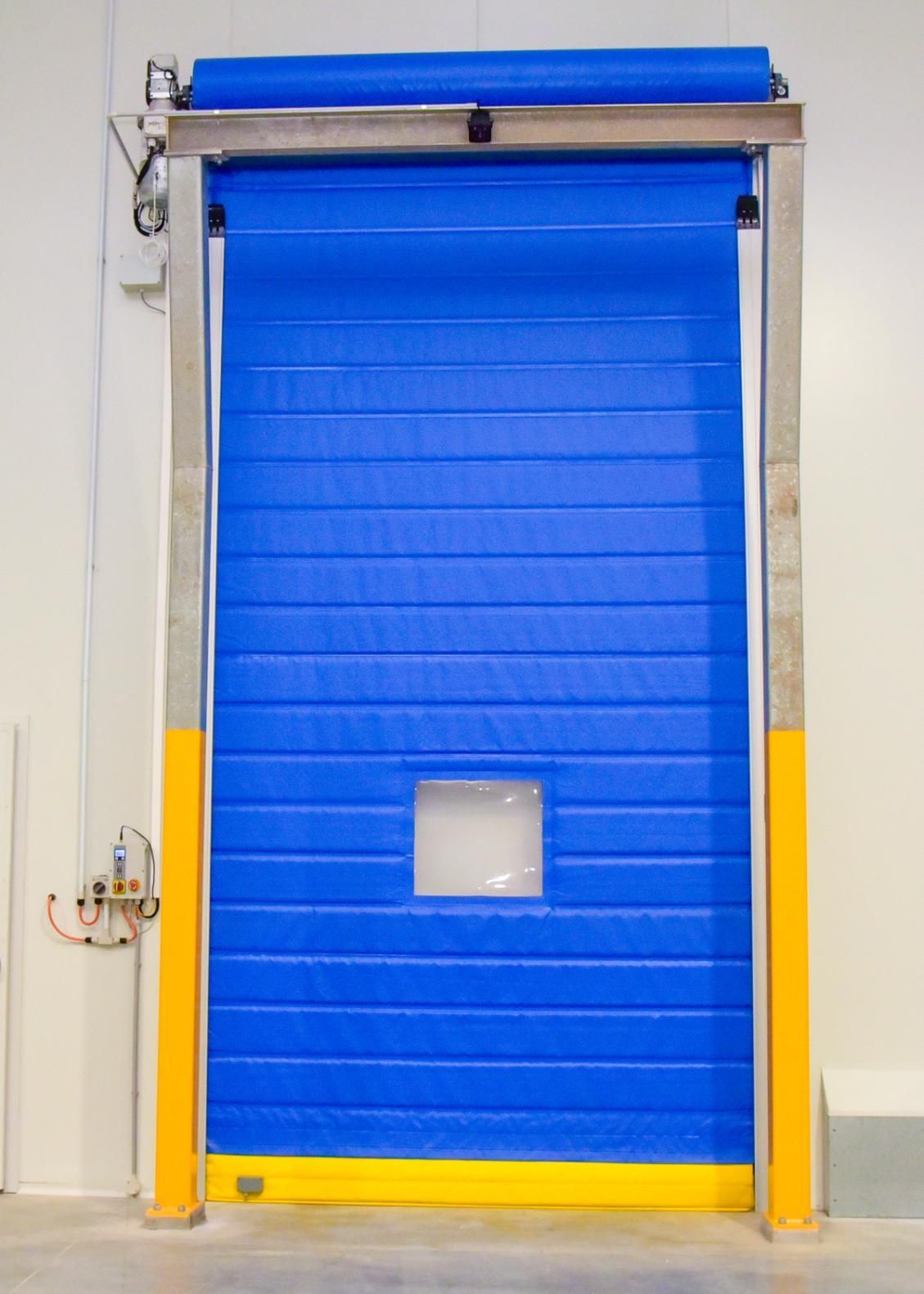A Blue Roller Door with A Yellow Frame Is Open in A Warehouse — Arctic Installations in Winnellie, NT