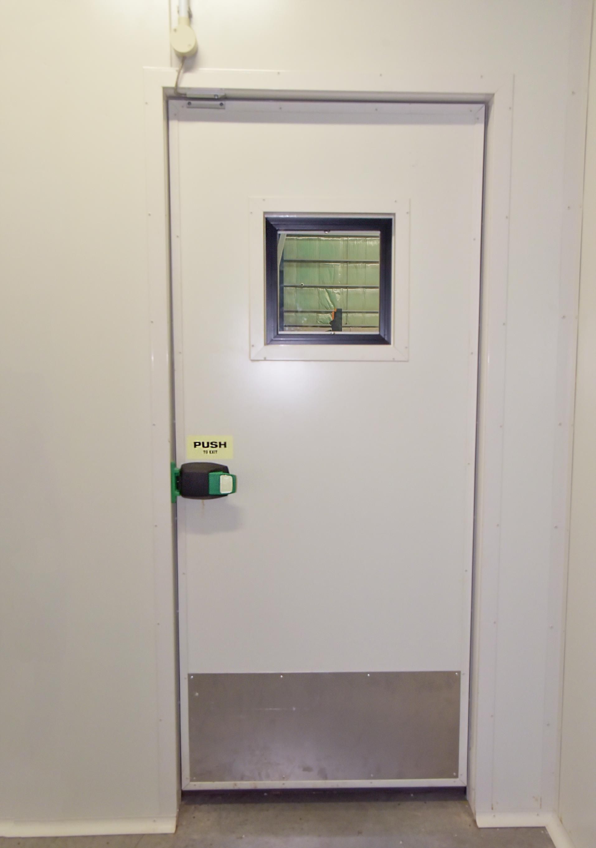 A White Door with A Small Window on It in A Room  — Arctic Installations in Winnellie, NT