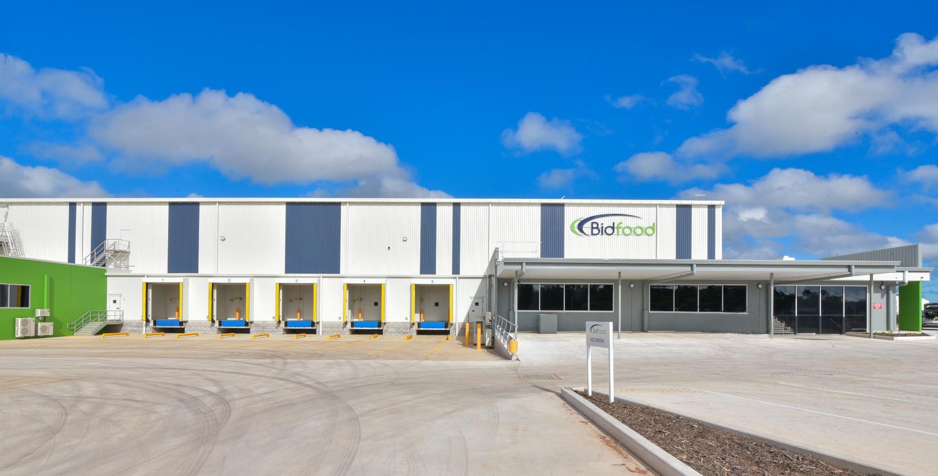 A Large Building with A Lot of Loading Docks in Front of It — Arctic Installations in Winnellie, NT