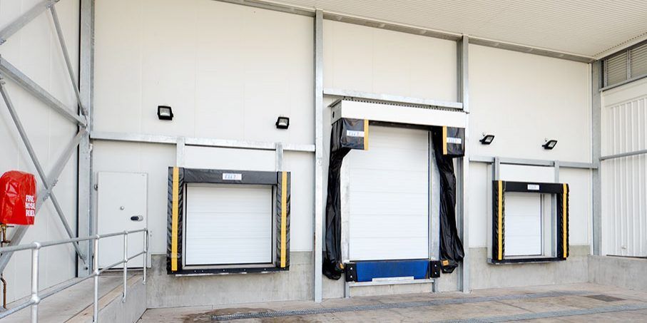 A Warehouse with A Lot of Doors and A Red Fire Extinguisher — Arctic Installations in Winnellie, NT