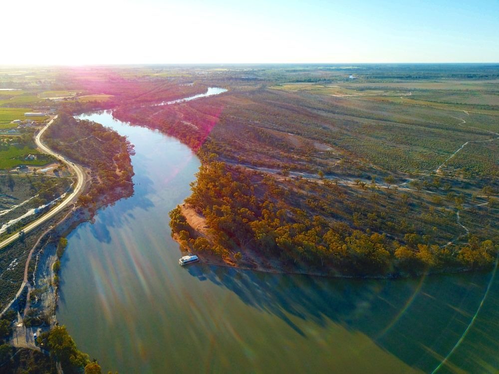 An Aerial View Of A River Surrounded By Trees And Fields — Arctic Installations in Mildura, VIC