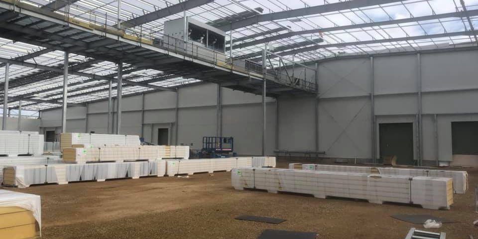 A Large Warehouse with A Lot of Boxes in It — Arctic Installations in Winnellie, NT