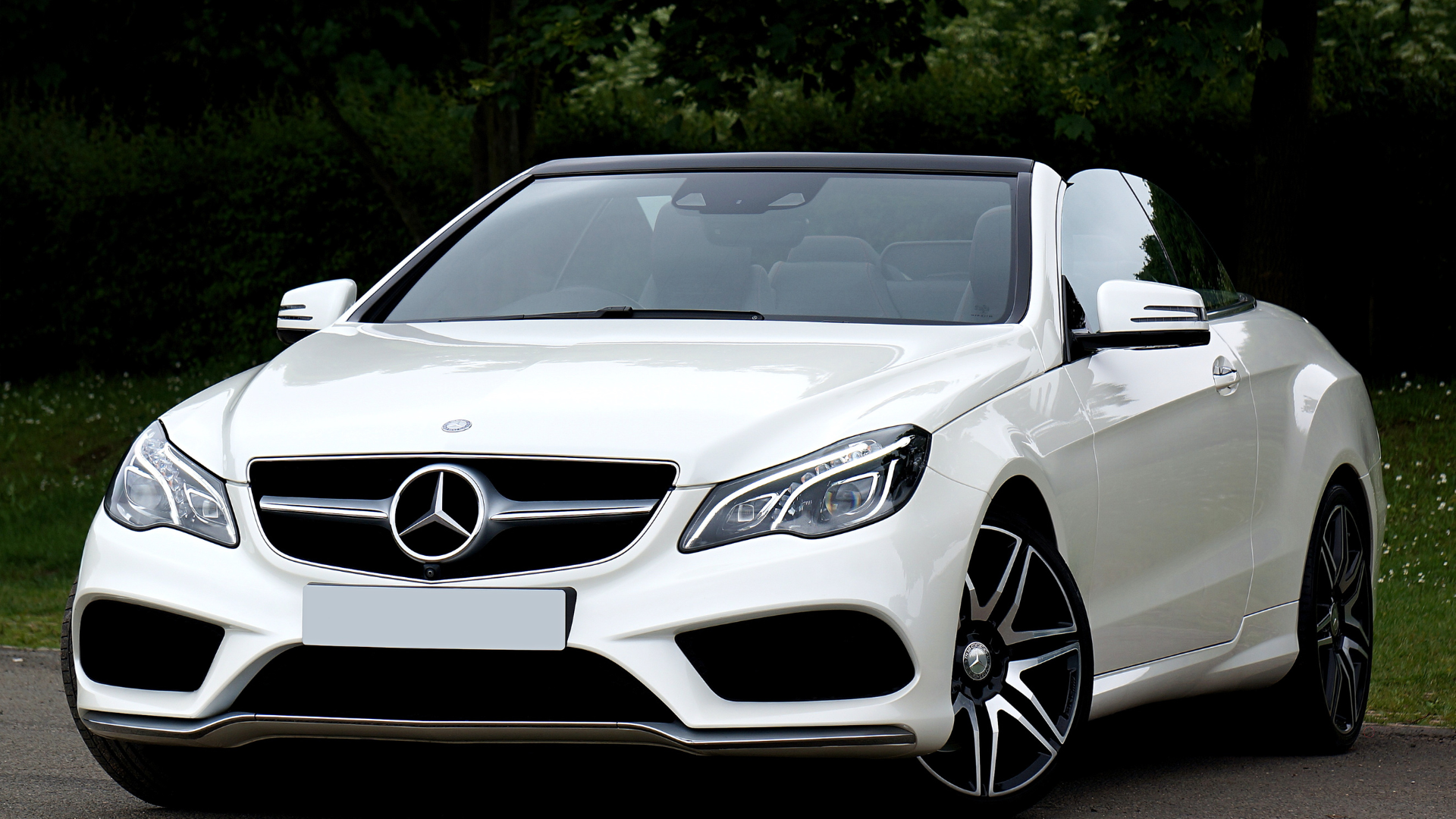 White Mercedes Benz convertible parked outdoors with a sleek and modern design.