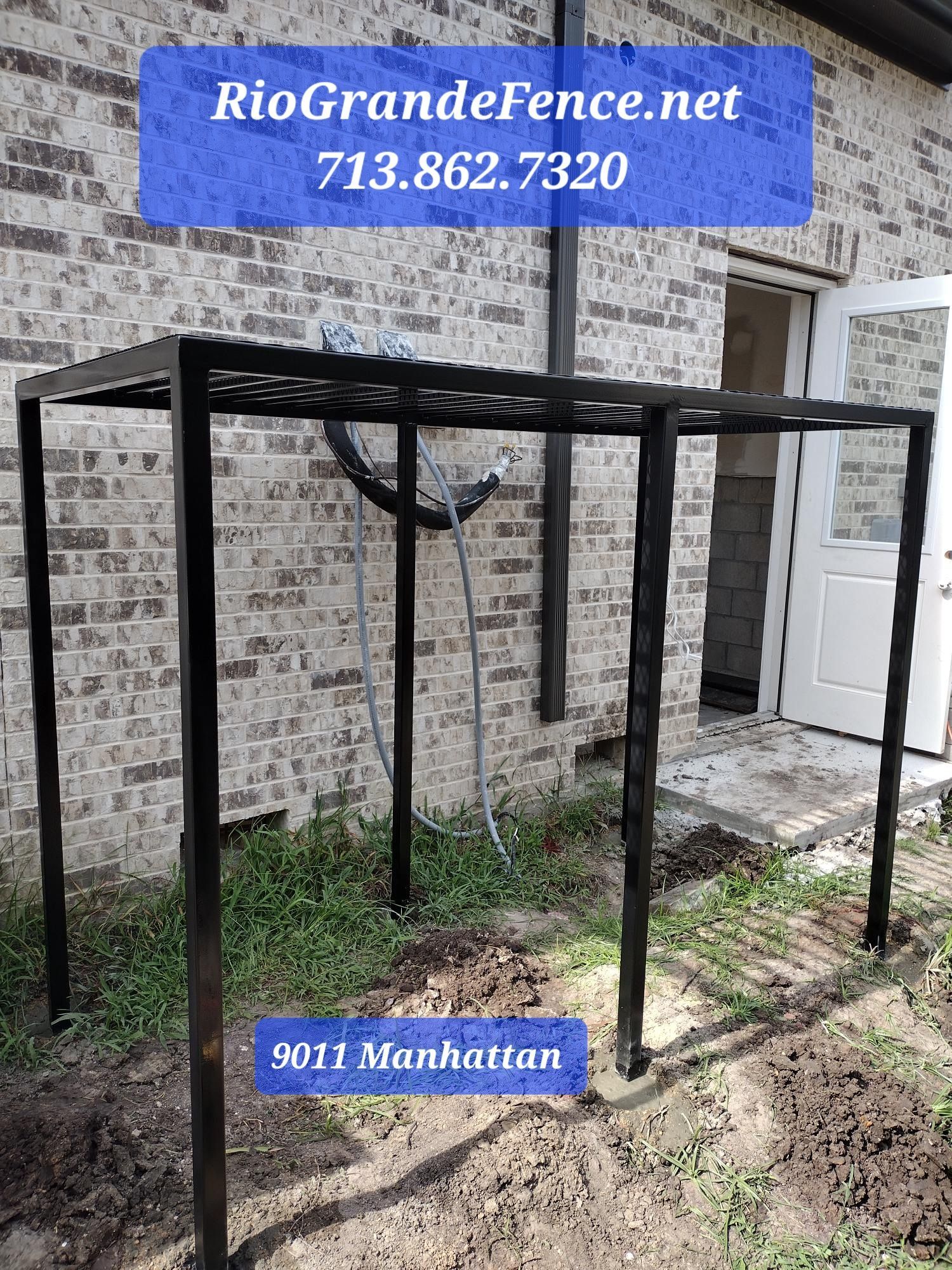A Metal Structure Is Sitting in Front of A Brick Building - Houston, TX - Rio Grande Fence Company