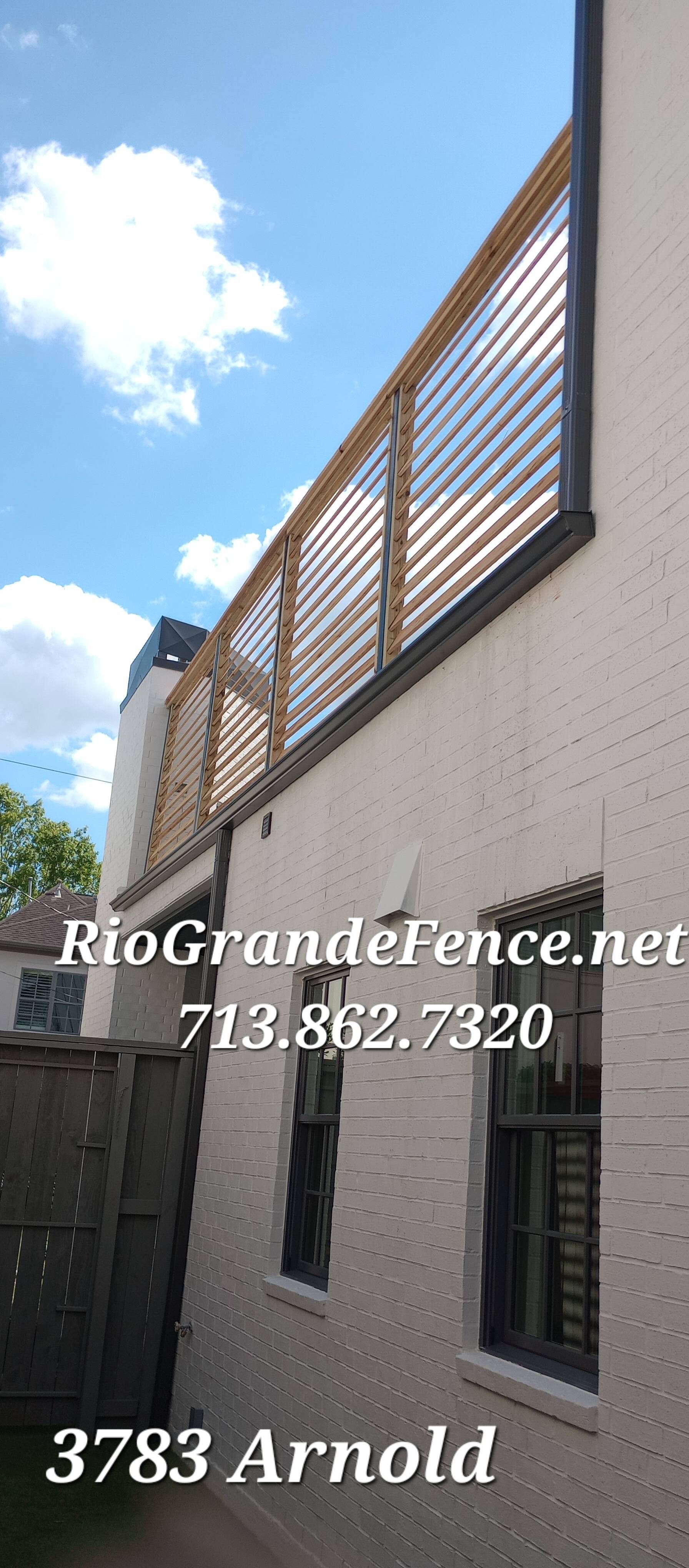 A White Building with A Fence on The Side of It - Houston, TX -  Rio Grande Fence Company
